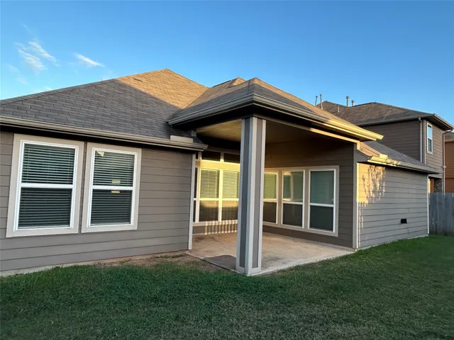 a view of a house with a large window and a yard