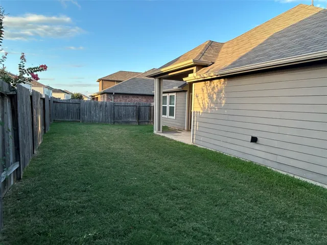a backyard of a house with lots of green space