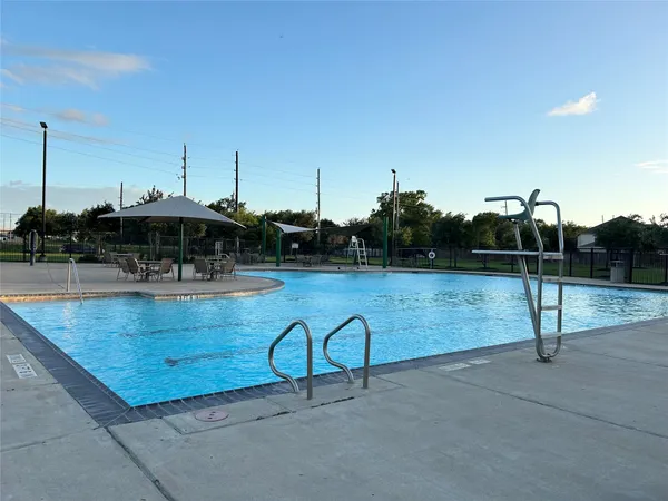 a view of swimming pool with seating space