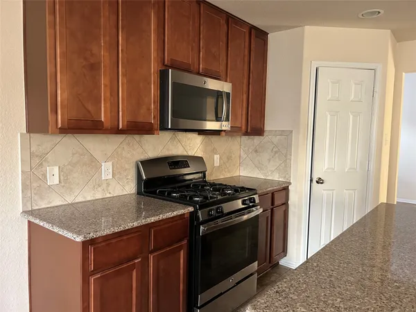 a kitchen with a stove and a microwave
