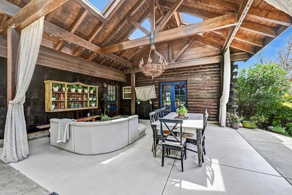 a building outdoor space with patio furniture and potted plants