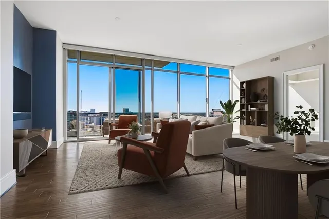 a living room with furniture rug and a window