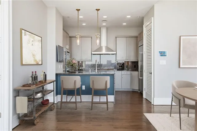 a view of kitchen with kitchen island stainless steel appliances refrigerator stove microwave and cabinets