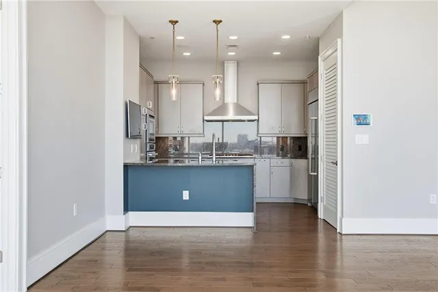 a kitchen with stainless steel appliances granite countertop a sink a stove and microwave