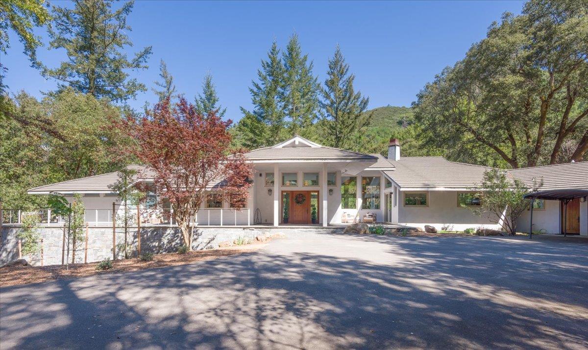 a front view of a house with a garden