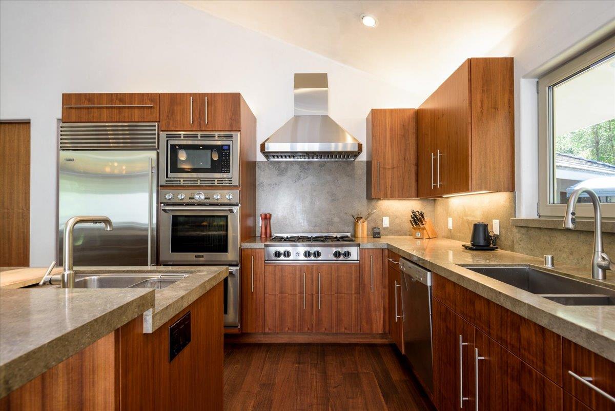 16345 Sanborn Road Saratoga, CA 95070 - Photo 14 of 31 a kitchen with a sink stove and cabinets