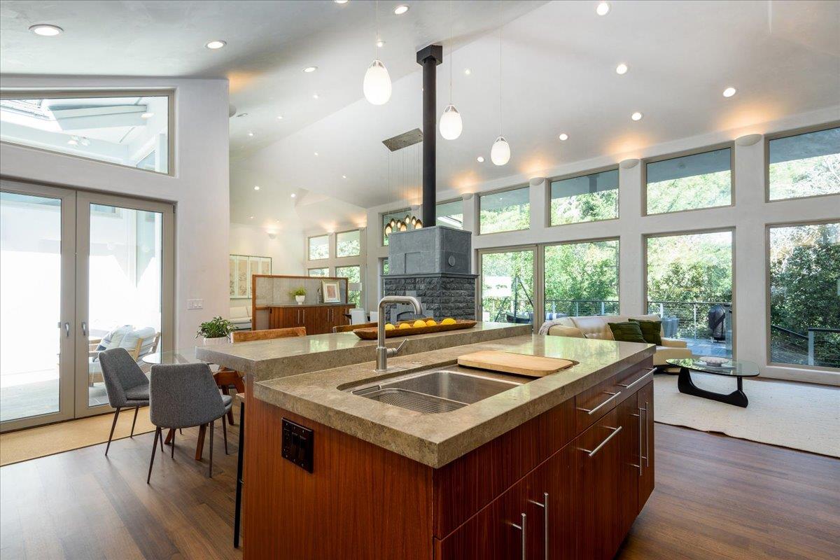 16345 Sanborn Road Saratoga, CA 95070 - Photo 15 of 31 a kitchen with a stove a sink a kitchen island with furniture and wooden floor