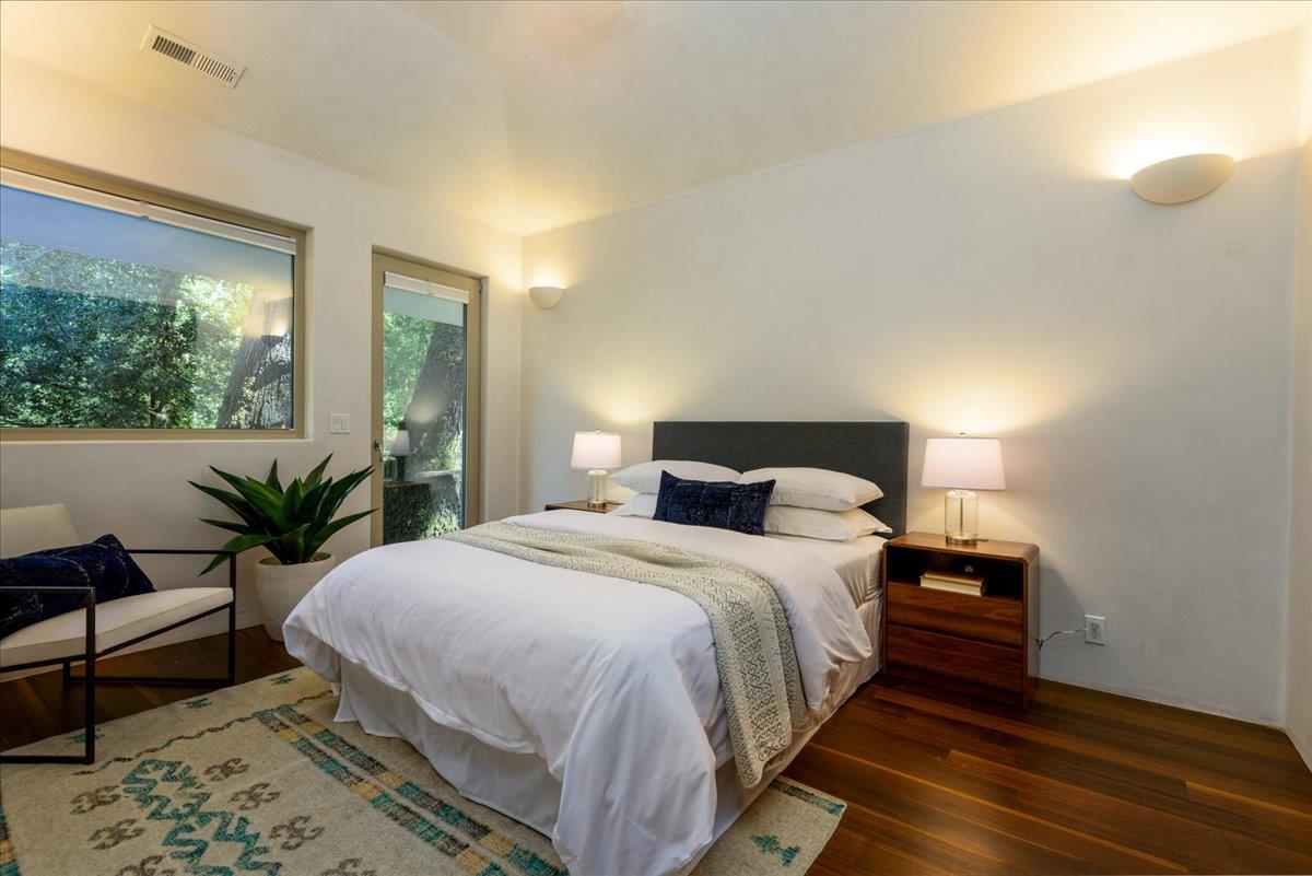 16345 Sanborn Road Saratoga, CA 95070 - Photo 17 of 31 a bedroom with a bed and wooden floor