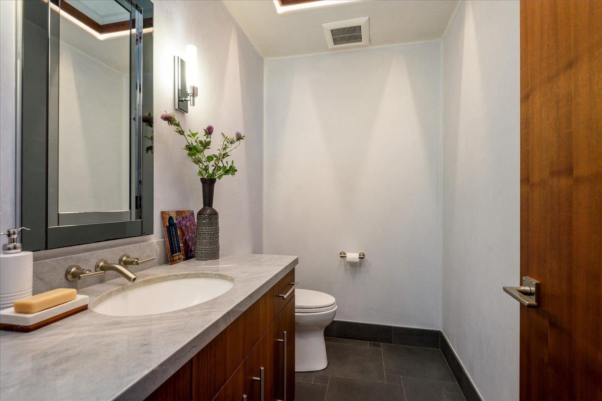 16345 Sanborn Road Saratoga, CA 95070 - Photo 19 of 31 a bathroom with a granite countertop sink and a mirror