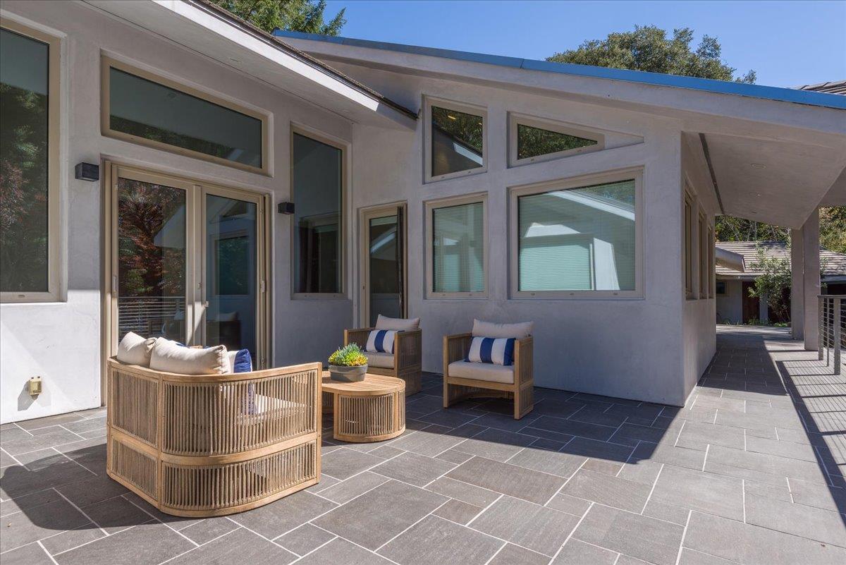 16345 Sanborn Road Saratoga, CA 95070 - Photo 25 of 31 a view of a patio with table and chairs and wooden floor