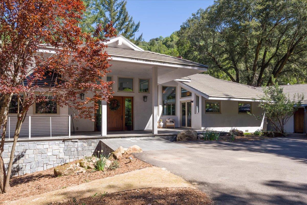 16345 Sanborn Road Saratoga, CA 95070 - Photo 31 of 31 a view of a white house with a large tree in front of it
