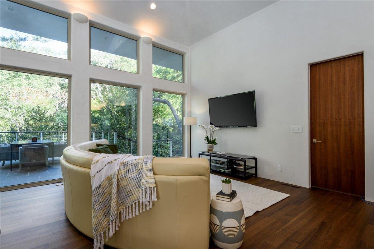 16345 Sanborn Road Saratoga, CA 95070 - Photo 10 of 31 a living room with furniture wooden floor and a flat screen tv