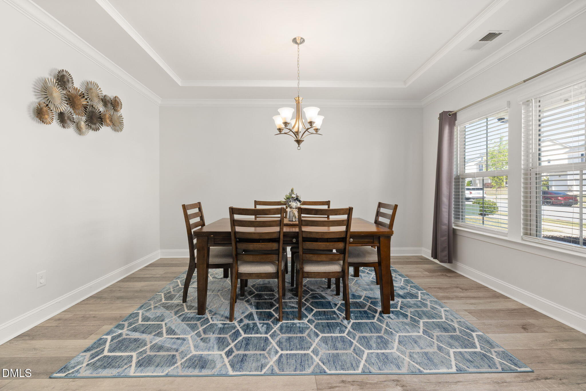 3422 Longleaf Estates Drive Raleigh, NC 27616 - Photo 8 of 71 a dining room with furniture a rug and a chandelier