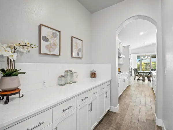 a kitchen with lots of clutter and cabinets