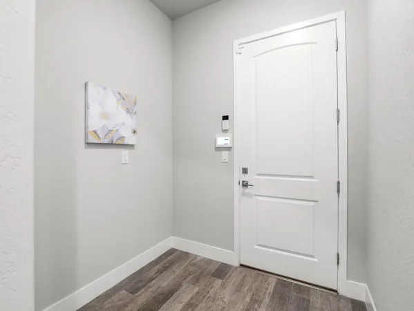 an empty room with a window and a ceiling fan