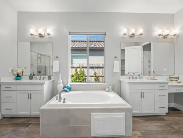 a bathroom with a double vanity sink mirror and shower