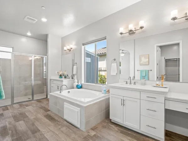 a bathroom with a double vanity sink a mirror and a shower