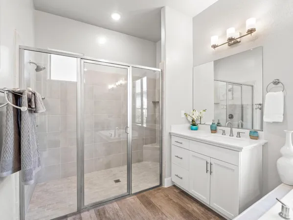 a bathroom with a tub sink and mirror