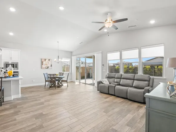 a large kitchen with lots of counter space a sink appliances and dining table