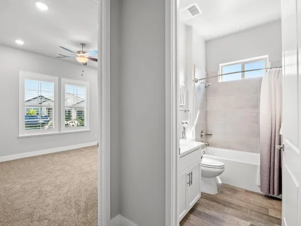 a bathroom with a granite countertop toilet a sink and a bathtub