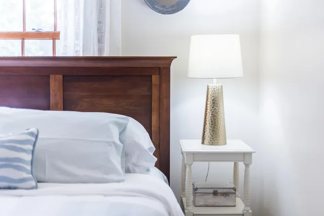 a bedroom with a bed and a night stand