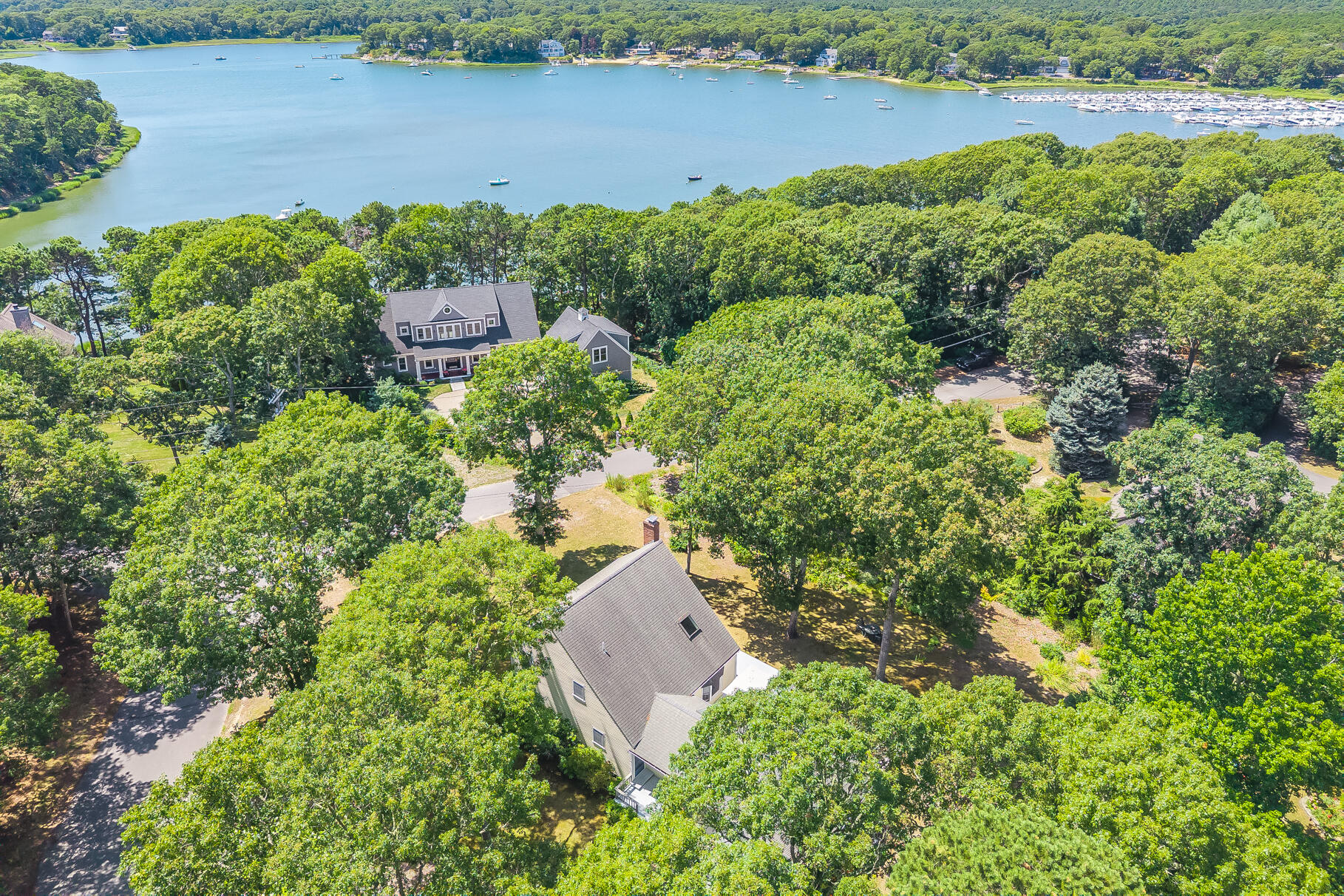 24 Tracey Road Cotuit, MA 02635 - Photo 2 of 45 an aerial view of a house with a yard and lake view
