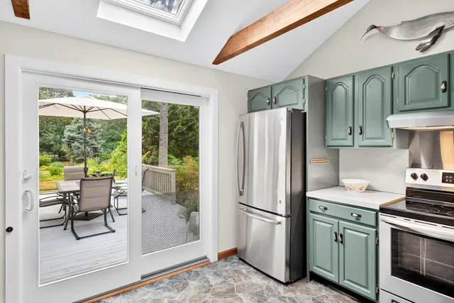 a kitchen with stainless steel appliances granite countertop a refrigerator and a stove