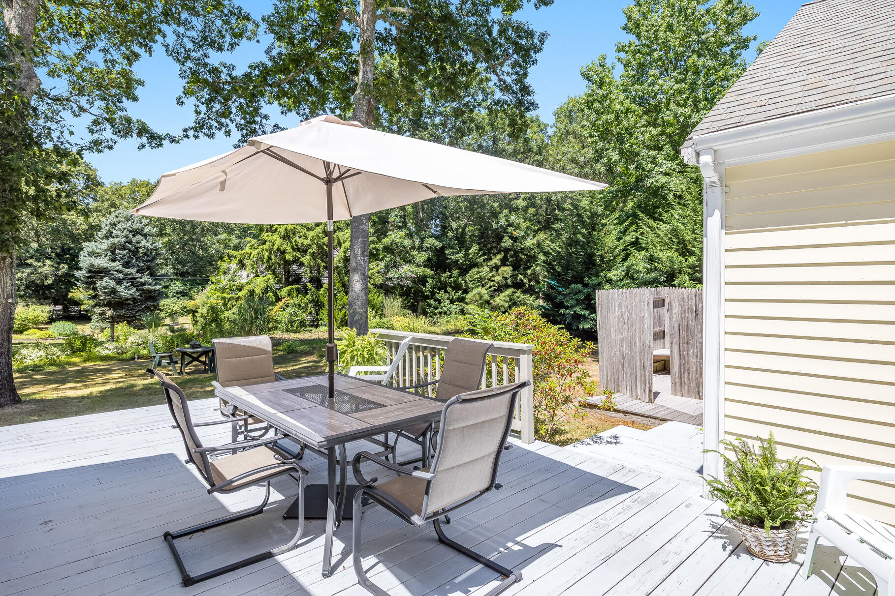 24 Tracey Road Cotuit, MA 02635 - Photo 28 of 45 a patio with wooden floor table and chairs