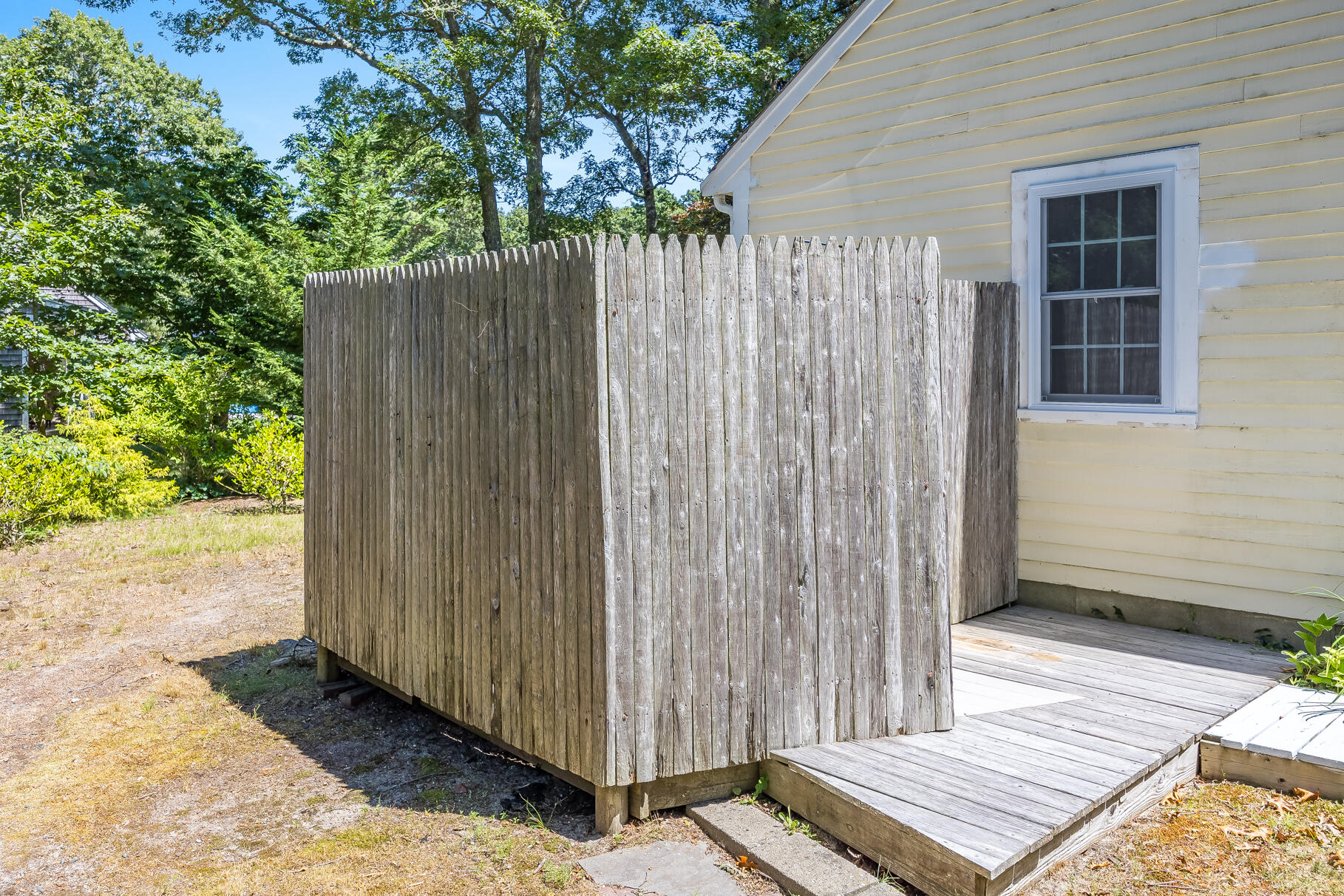 24 Tracey Road Cotuit, MA 02635 - Photo 30 of 45 a view of a backyard with wooden fence