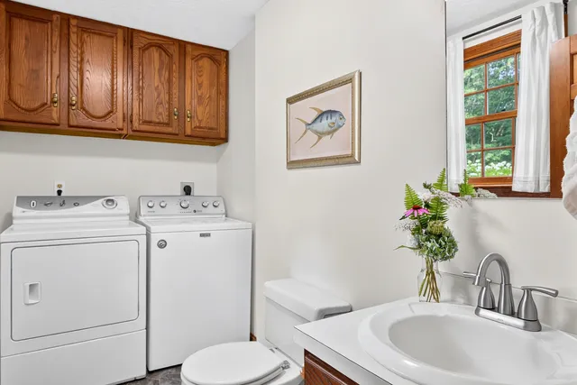 a bathroom with a toilet sink and mirror