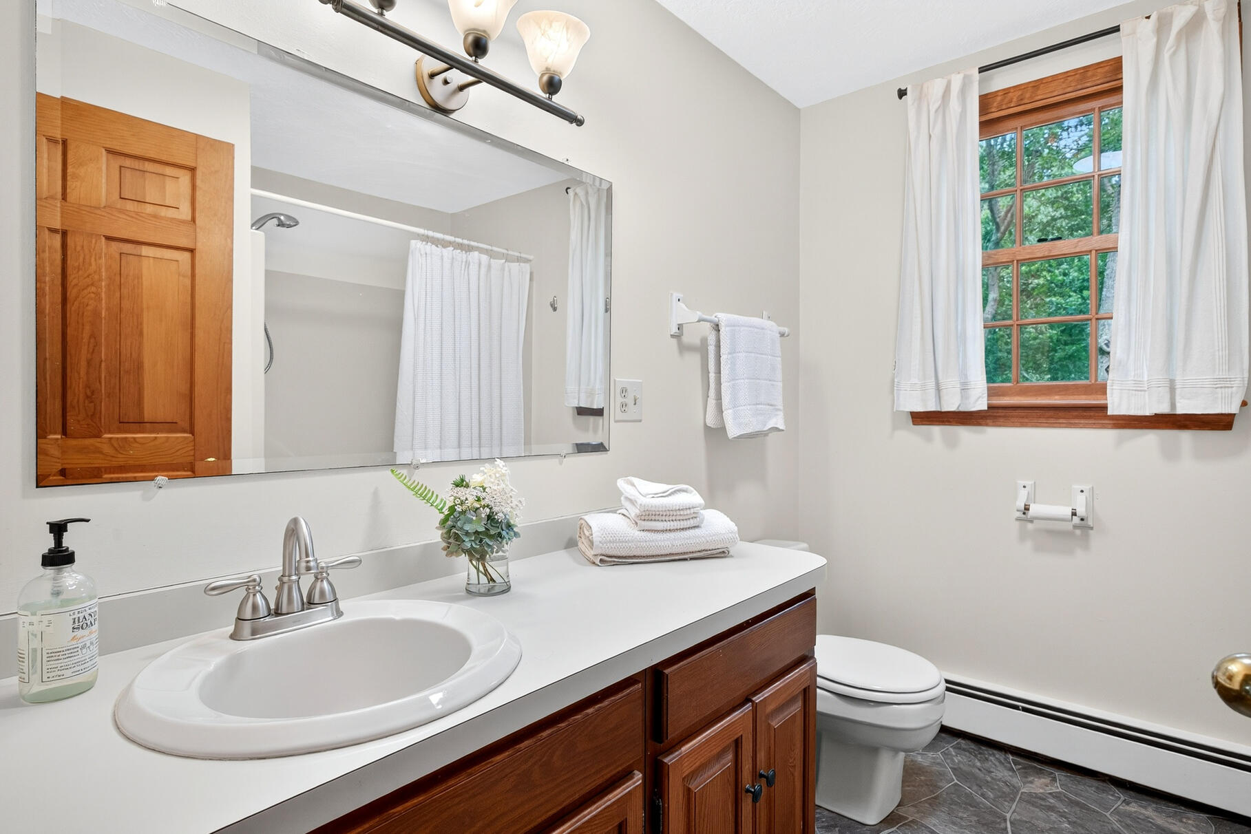 24 Tracey Road Cotuit, MA 02635 - Photo 37 of 45 a bathroom with a granite countertop sink toilet and a mirror