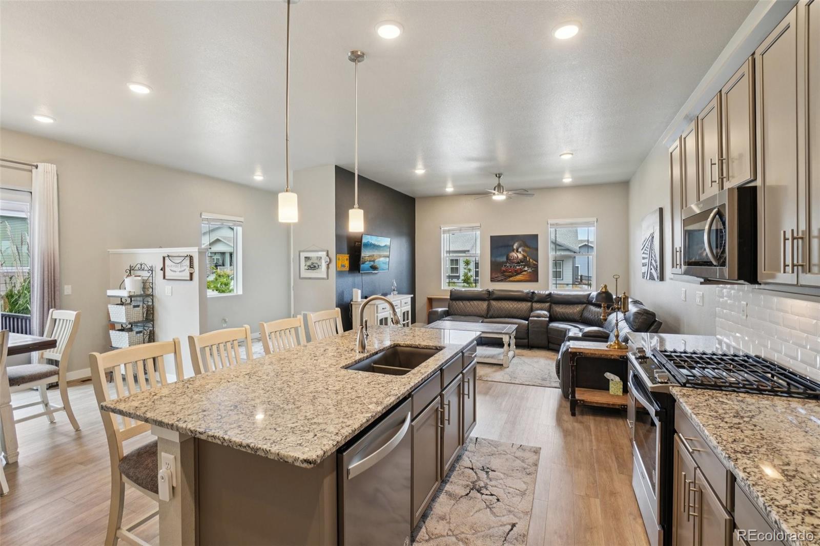 a kitchen with counter space appliances and a living room view