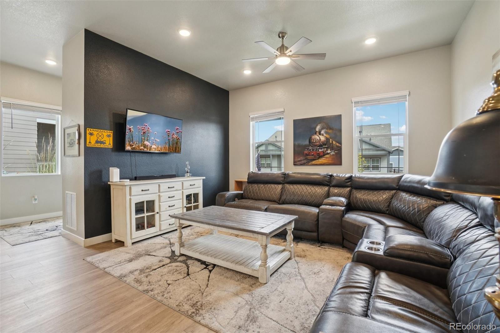 12541 Lake View Street Firestone, CO 80504 - Photo 11 of 50 a living room with fireplace furniture and a flat screen tv