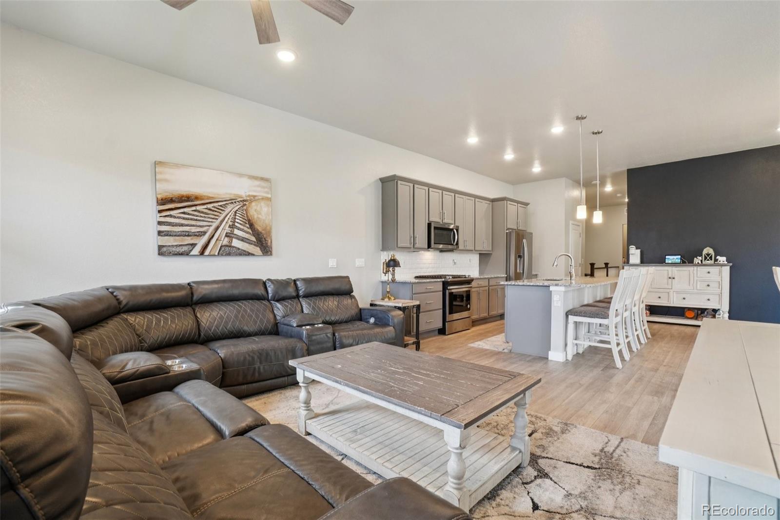 12541 Lake View Street Firestone, CO 80504 - Photo 12 of 50 a living room with furniture kitchen view and a dining table