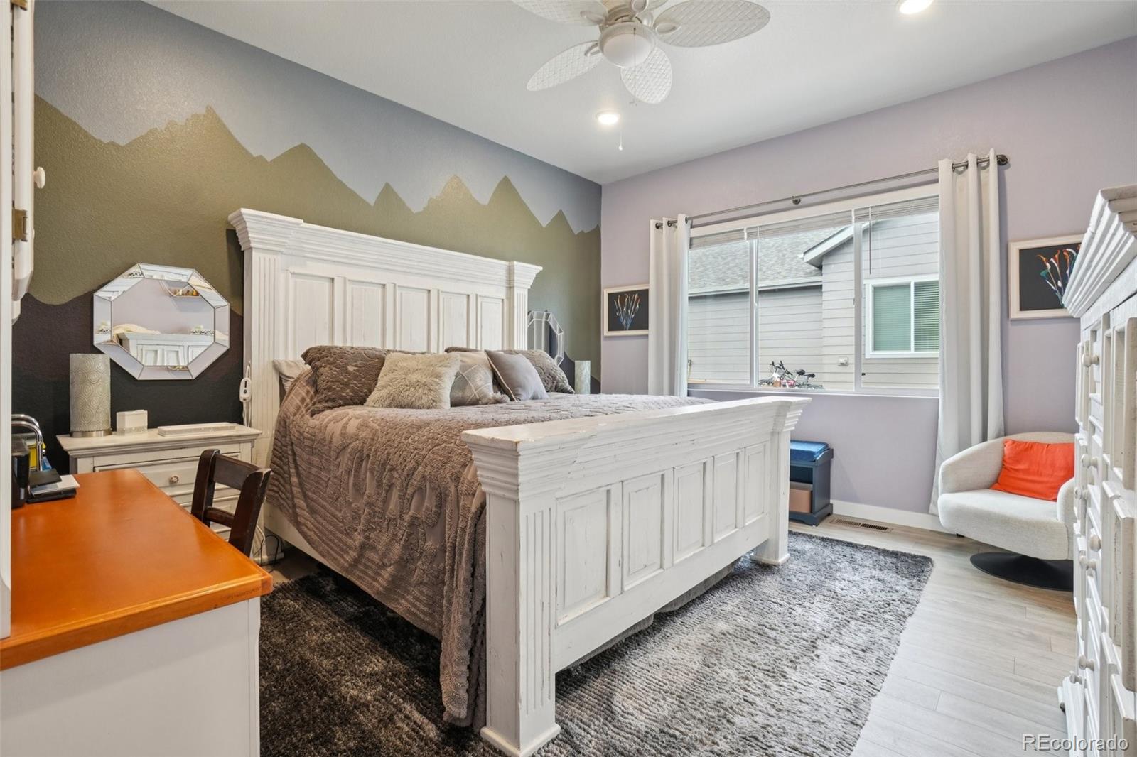 12541 Lake View Street Firestone, CO 80504 - Photo 15 of 50 a bedroom with a bed and a chandelier