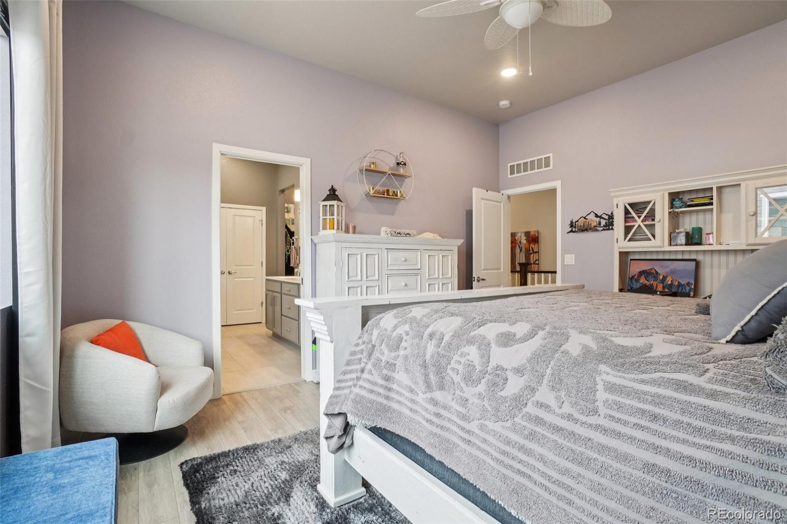 12541 Lake View Street Firestone, CO 80504 - Photo 17 of 50 a bedroom with a bed and wooden floor