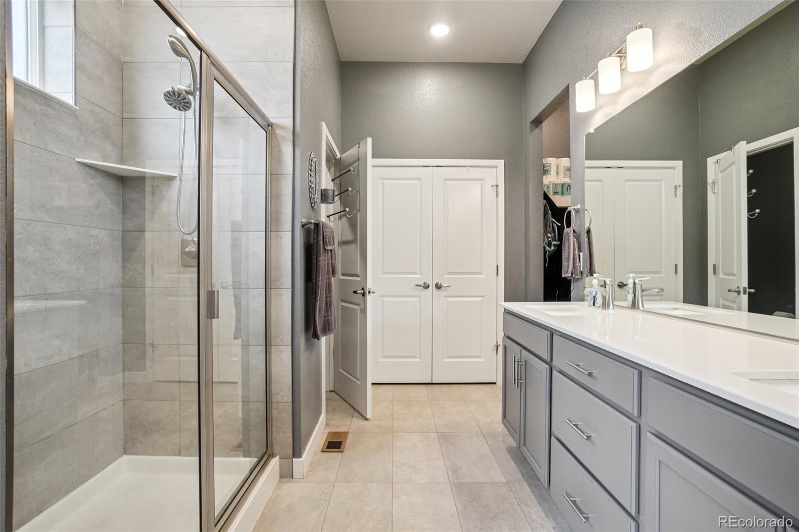 12541 Lake View Street Firestone, CO 80504 - Photo 19 of 50 a spacious bathroom with a shower sink and mirror