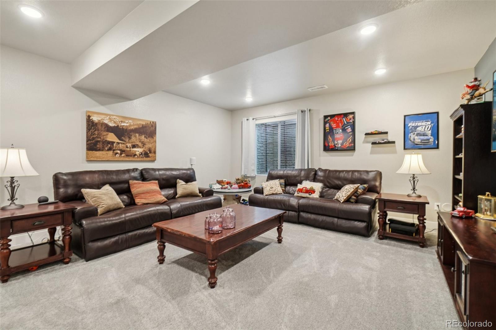 12541 Lake View Street Firestone, CO 80504 - Photo 23 of 50 a living room with furniture and a flat screen tv