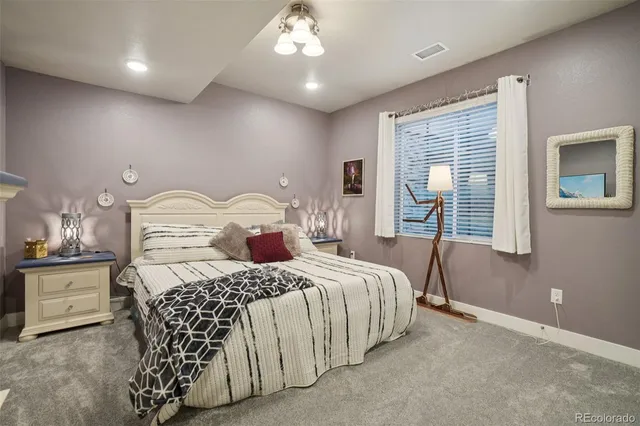 a bedroom with a bed and a flat tv screen