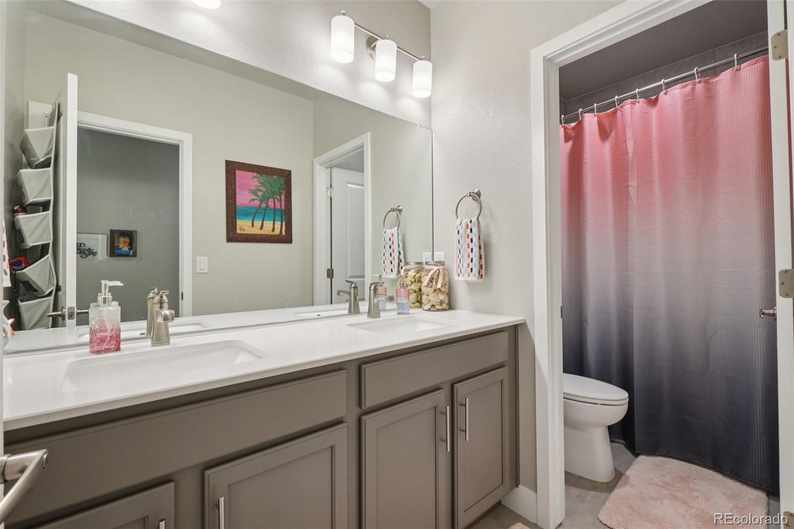 12541 Lake View Street Firestone, CO 80504 - Photo 27 of 50 a bathroom with a granite countertop sink a toilet and a mirror