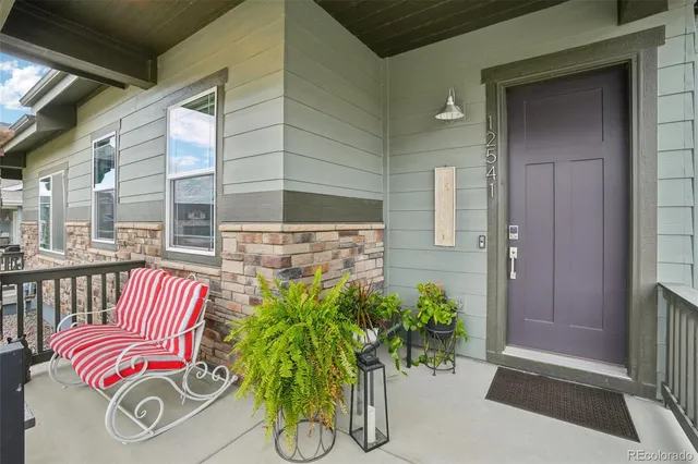 a kitchen with granite countertop a sink stove and refrigerator