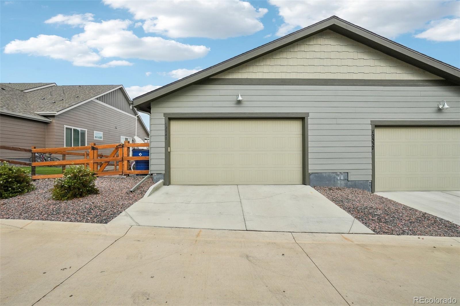 12541 Lake View Street Firestone, CO 80504 - Photo 36 of 50 a front view of a house with a yard and garage