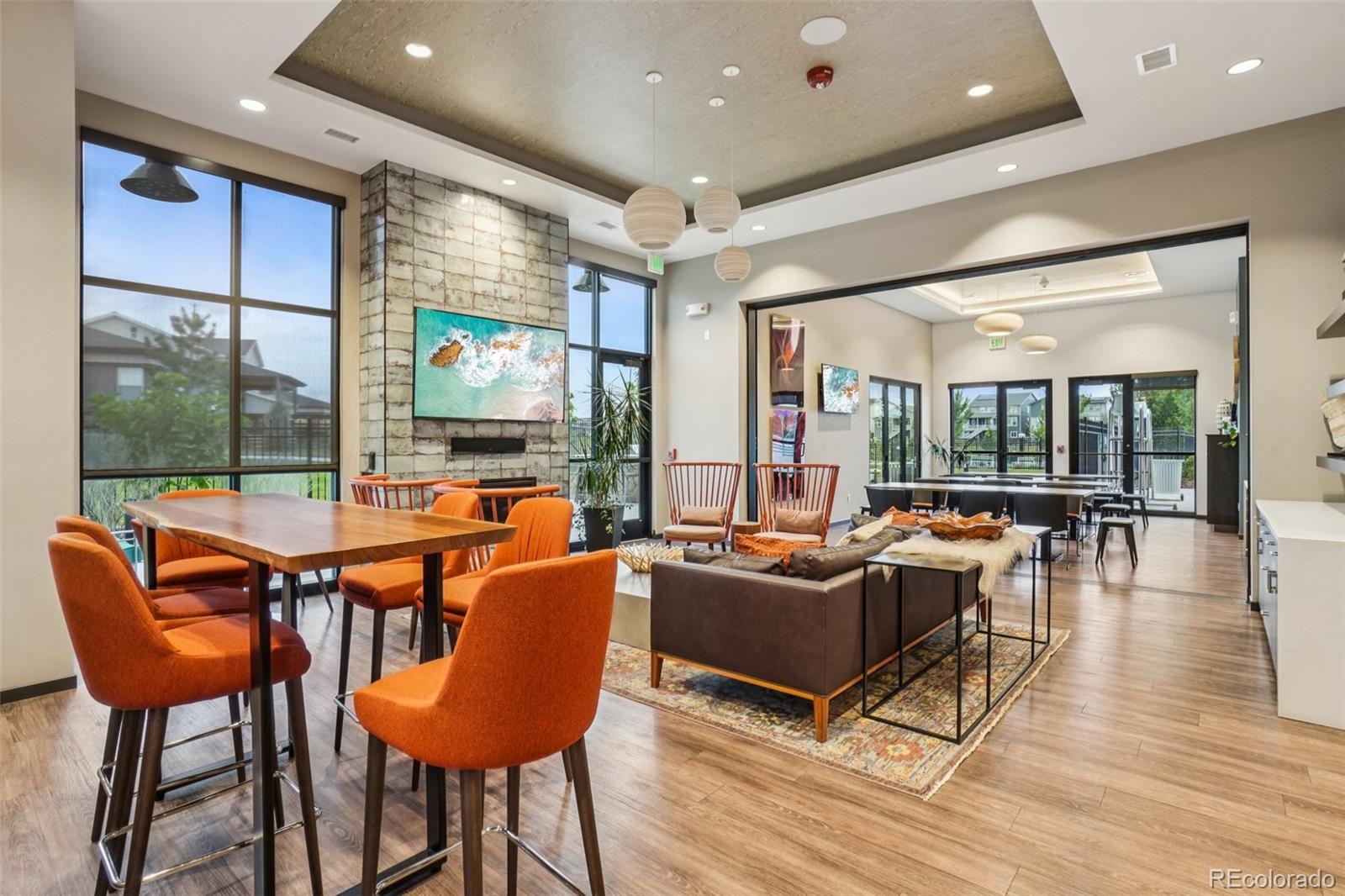 12541 Lake View Street Firestone, CO 80504 - Photo 41 of 50 a living room with furniture a flat screen tv and floor to ceiling window