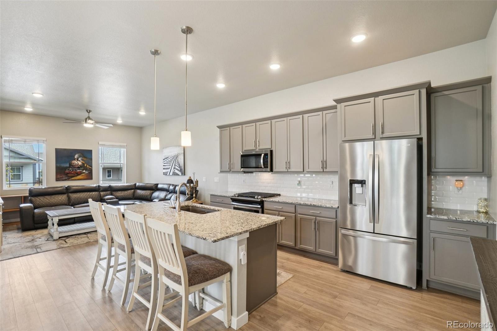12541 Lake View Street Firestone, CO 80504 - Photo 7 of 50 a kitchen with stainless steel appliances a refrigerator a stove a sink a dining table and chairs