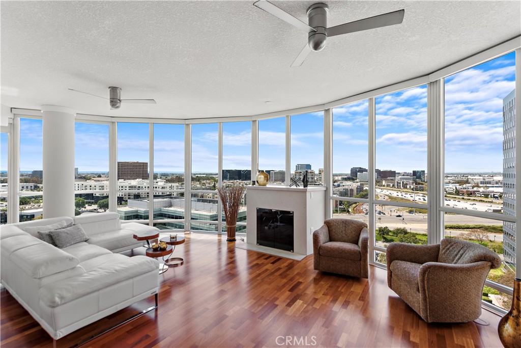 a living room with furniture fireplace and a large window