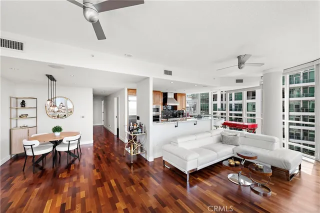 a bedroom with a bed and a potted plant on the dresser