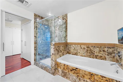 a bathroom with a bathtub and a shower