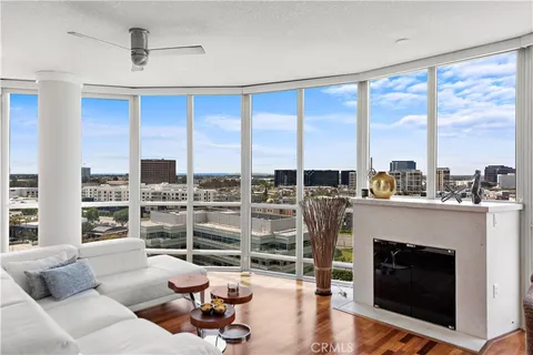 a living room with furniture a large window and a fireplace