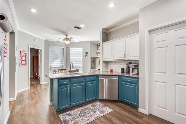 a kitchen with stainless steel appliances granite countertop a sink and cabinets
