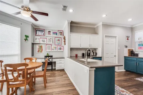 a kitchen with granite countertop cabinets a dining table and chairs